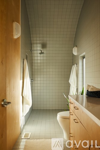 A bathroom with a toilet, sink, and shower.