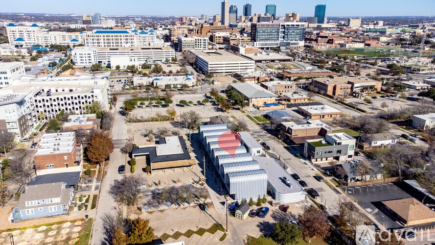 A cityscape with buildings and a clear sky.