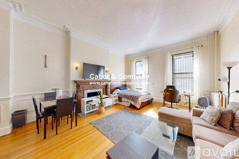 A well-lit, spacious living room with a fireplace and a dining area.