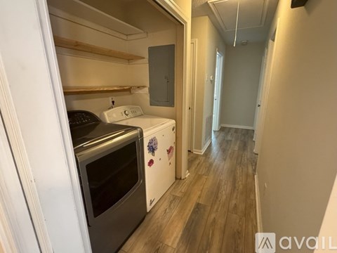 A kitchen with a white oven and a white washing machine.
