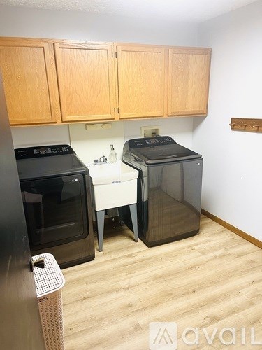 A kitchen with wooden cabinets and a black oven.