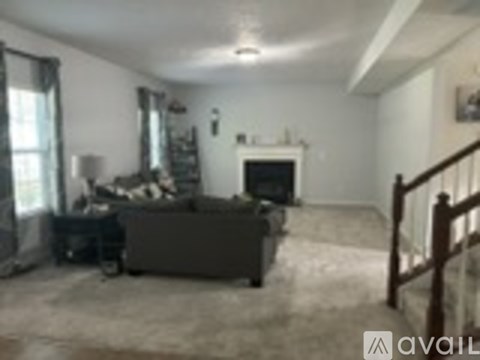 A living room with a couch and a fireplace.