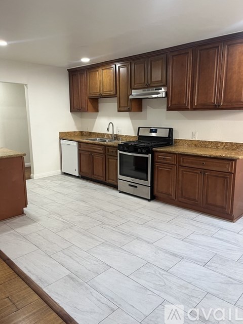 A kitchen with brown cabinets and a white countertop.