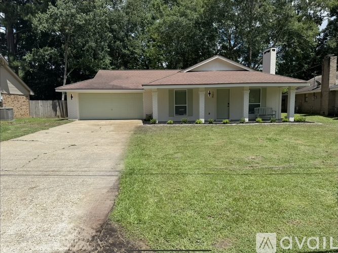 A house with a brown roof and a white garage door.