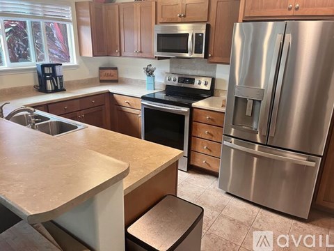 A kitchen with a stainless steel refrigerator and oven.