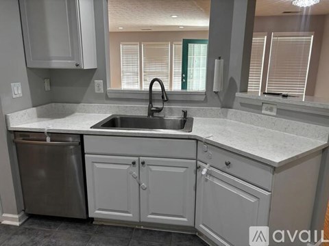 A kitchen with a sink and a dishwasher.