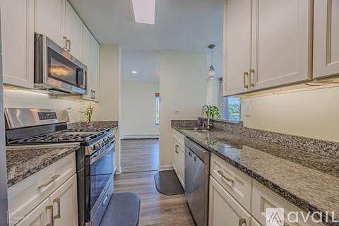 A kitchen with granite countertops and stainless steel appliances.