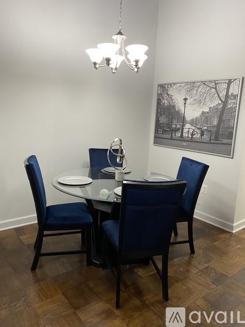 A dining room with a table and chairs.