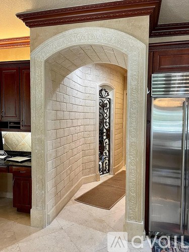 A white arched doorway with a metal handle.