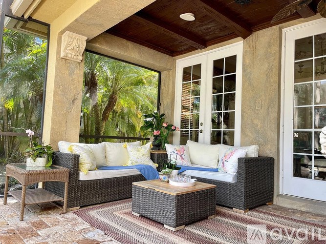 A patio with a sofa, table, and chairs.