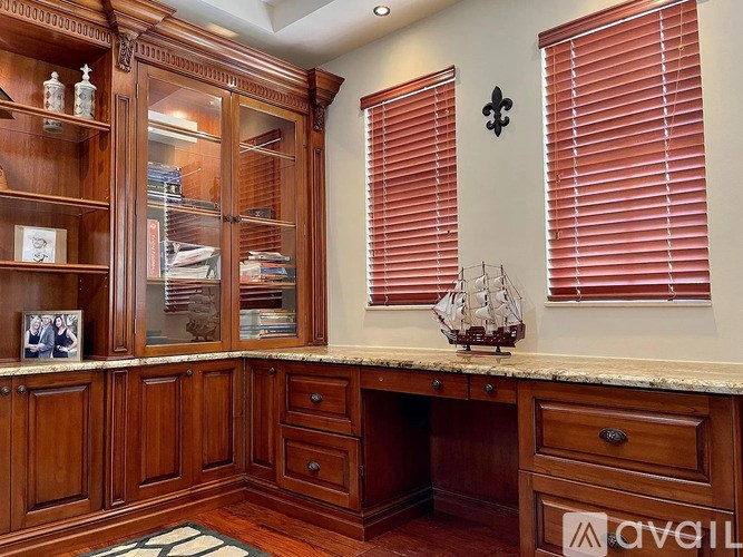 A home office with a desk, drawers, and a bookcase.