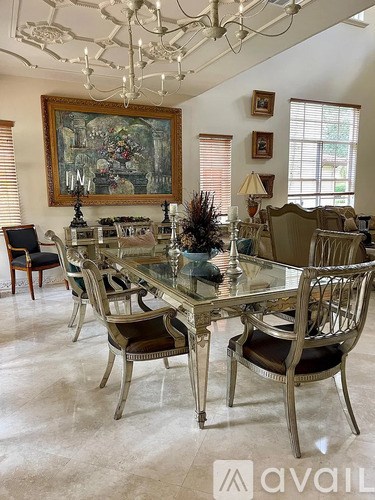 A dining room with a glass table and chairs.