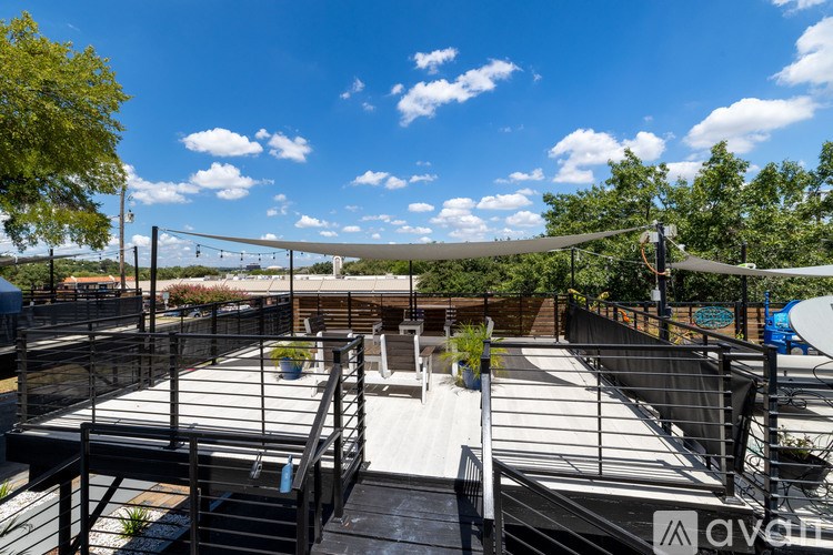 A rooftop with a pool and a slide.