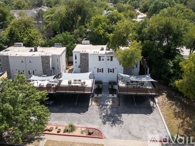 A large white house with a deck and a driveway.