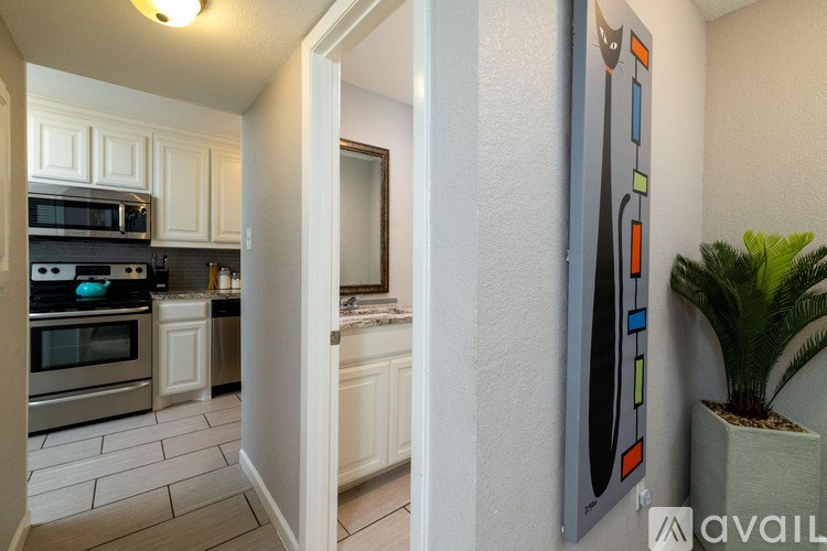 A kitchen with white cabinets and a microwave above the stove.