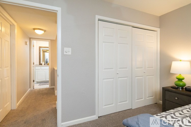 A bedroom with a bed, dresser, and mirror.