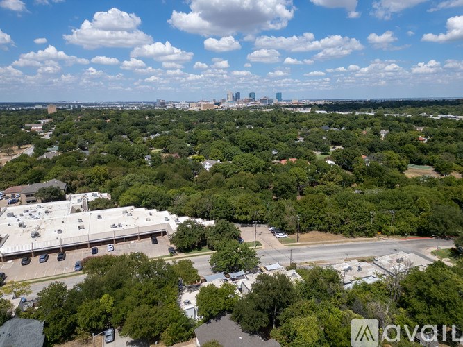 A cityscape with a large green area in the foreground and buildings in the distance.