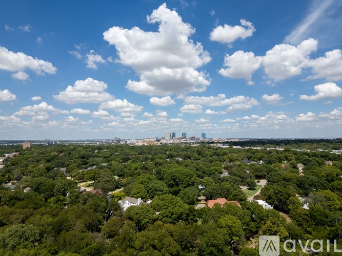 A bird's eye view of a city surrounded by greenery.