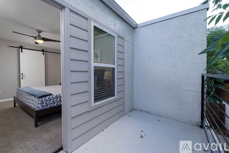 A bedroom with a bed and a ceiling fan.