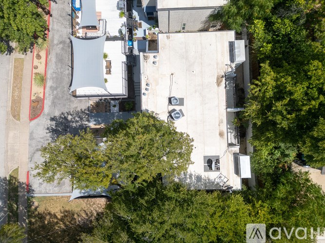 A car is parked in a parking lot in front of a building.
