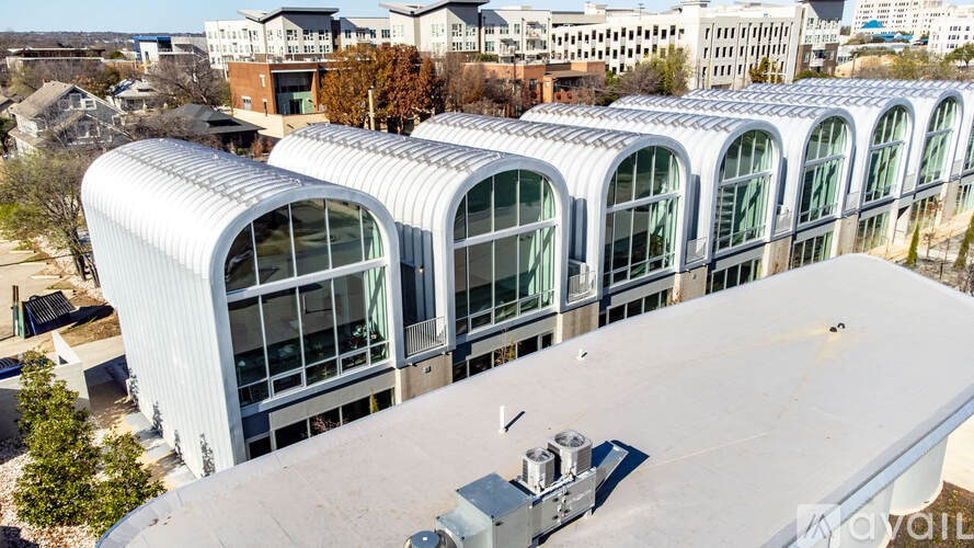 A modern building with a curved roof and large windows.