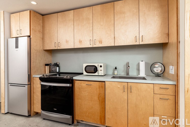A kitchen with wooden cabinets and a black stove top oven.