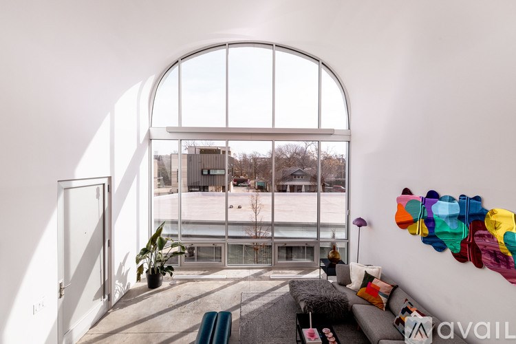 A living room with a large window and a couch.