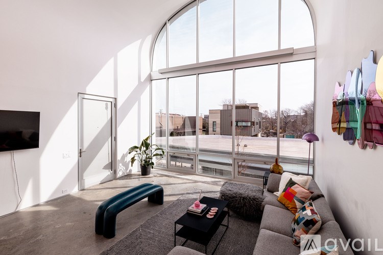 A living room with a grey couch and a black coffee table.