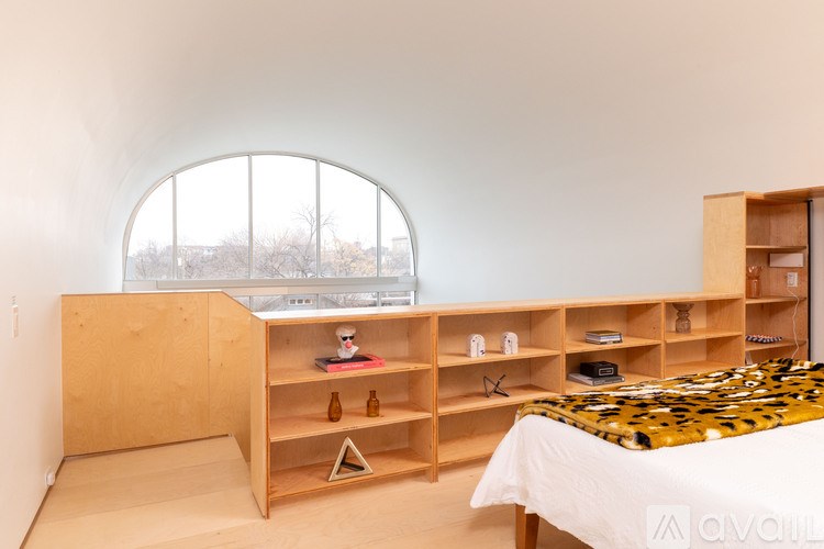 A bedroom with a leopard print bedspread and wooden furniture.