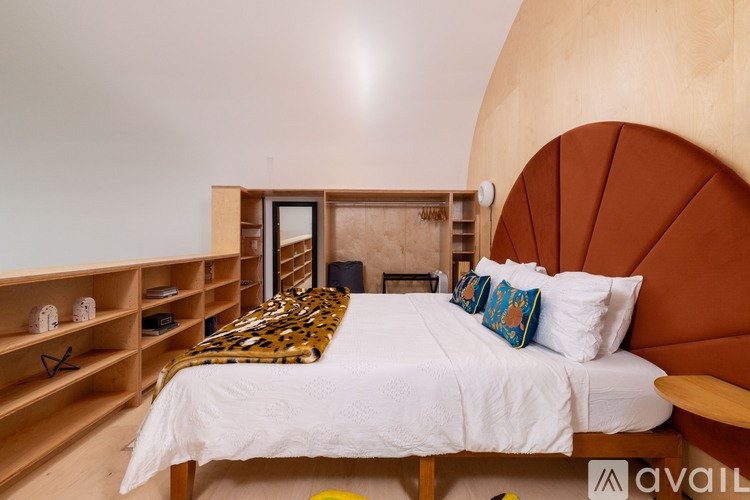 A bedroom with a leopard print throw on the bed.
