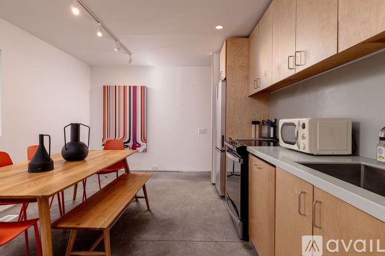 A kitchen with a table and chairs in front of a striped curtain.