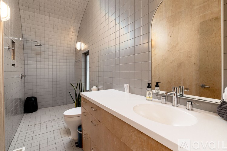A bathroom with a white sink and a toilet.