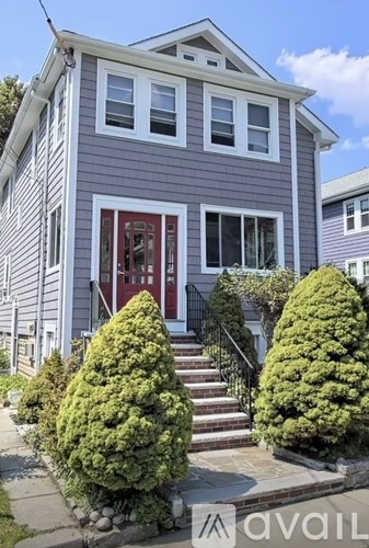 A house with a red door and a red window is for sale.