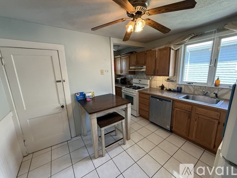 A kitchen with a table and chairs in the middle of it.