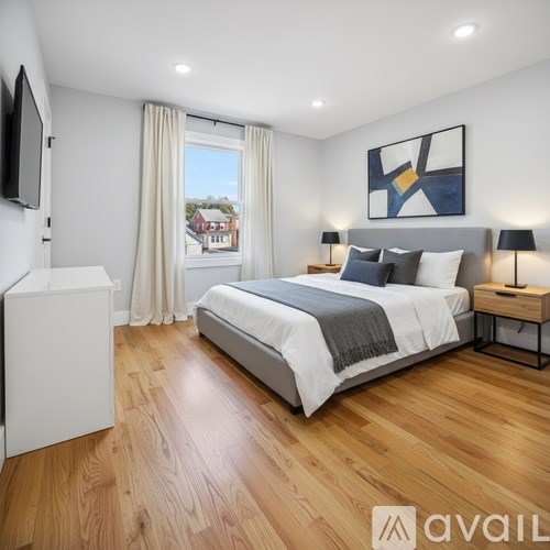 A room with wooden flooring and a window.