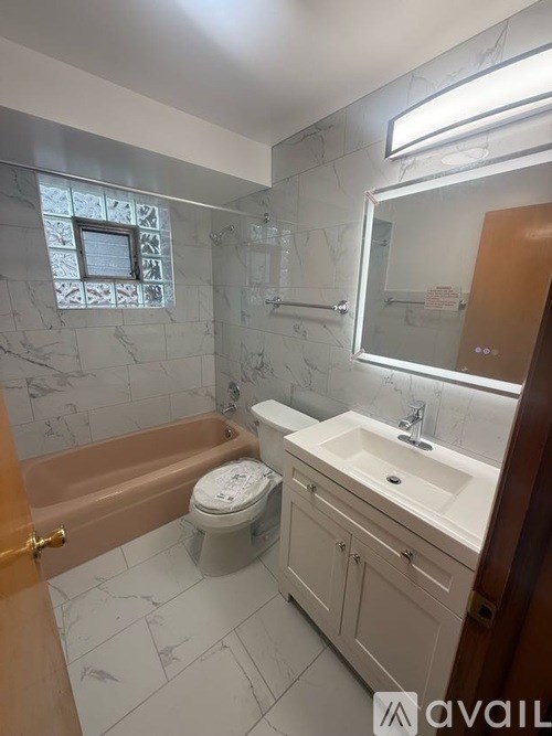 A bathroom with a toilet, sink, and bathtub.
