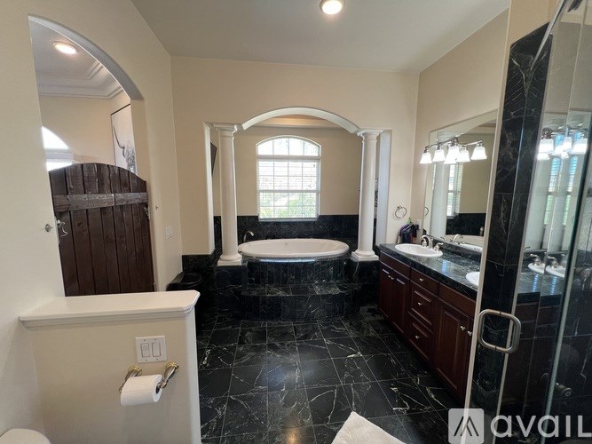 A bathroom with a toilet, sink, and bathtub.