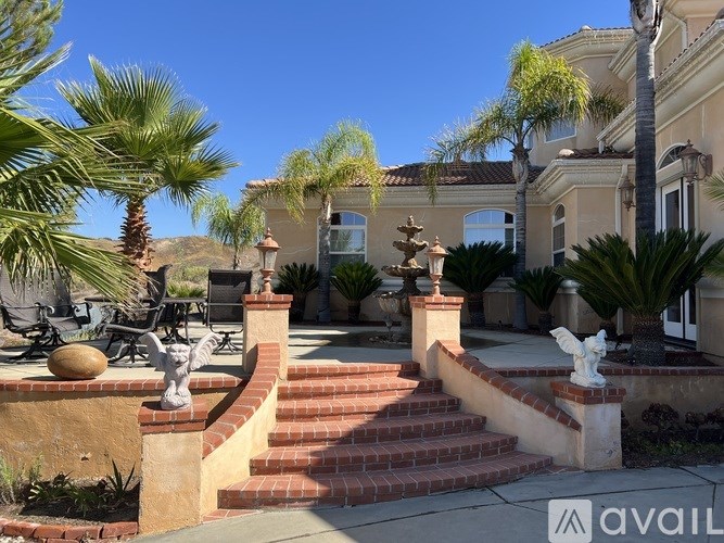 A house with a red staircase leading to the front door.