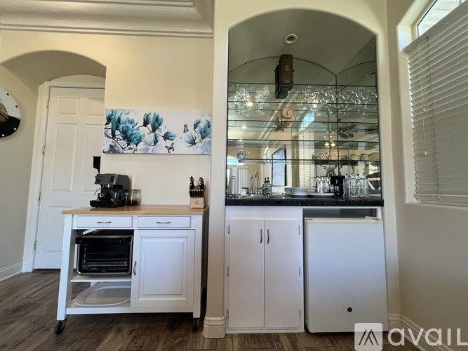 A kitchen with a white oven and cabinets.