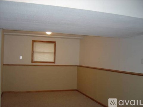 A room with a window and a light on the ceiling.
