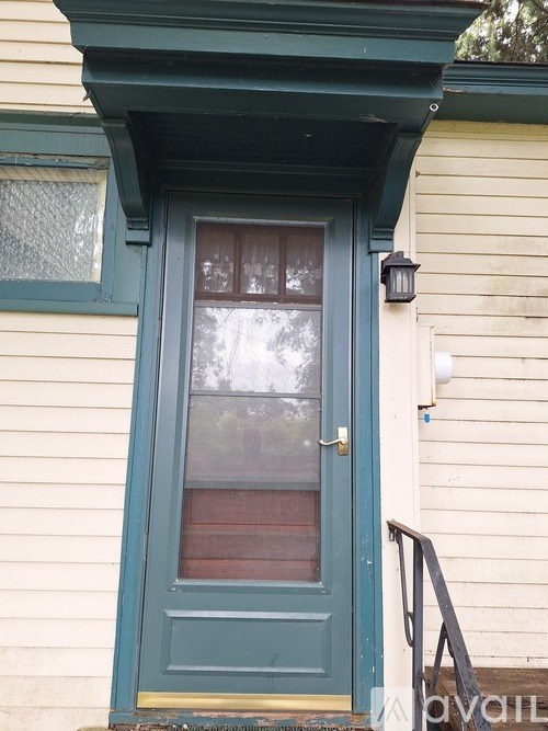 A blue door with a window above it.