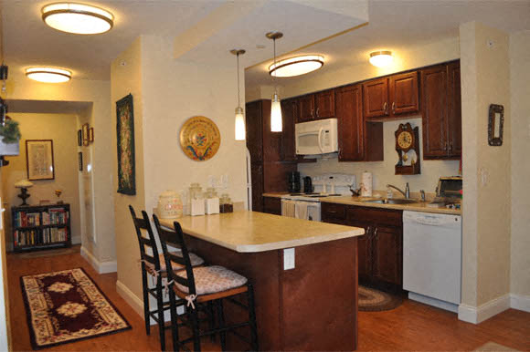 A kitchen with a white dishwasher and a white washing machine.