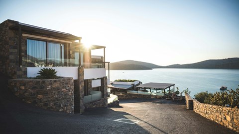 A house with a patio overlooking a body of water.