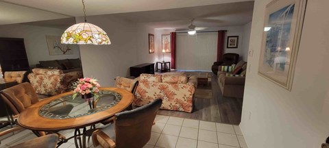 A living room with a glass table and chairs.
