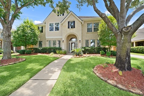 A house with a tree in front of it.