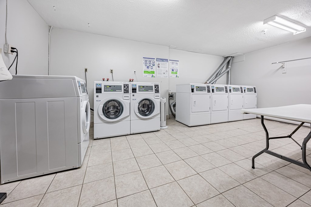 A laundry room with washers and dryers.