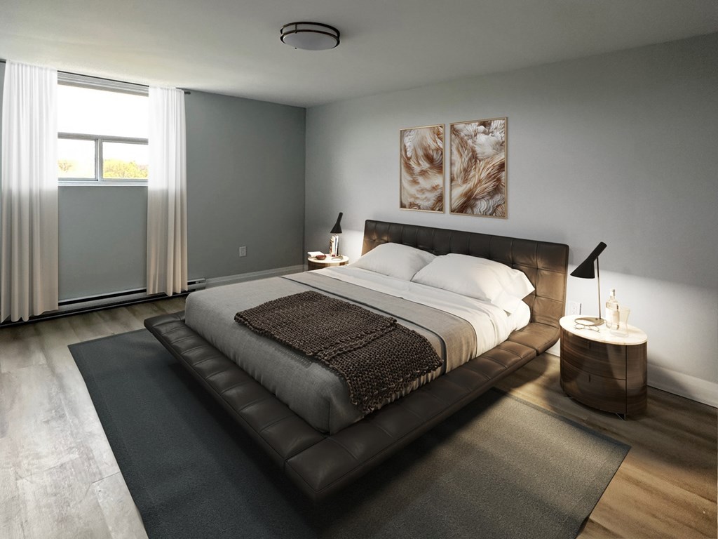 A bedroom with a large bed and a painting on the wall.