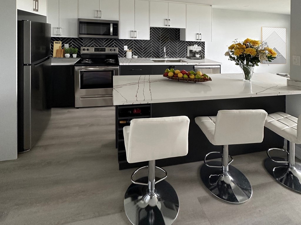 A modern kitchen with a black and white color scheme.
