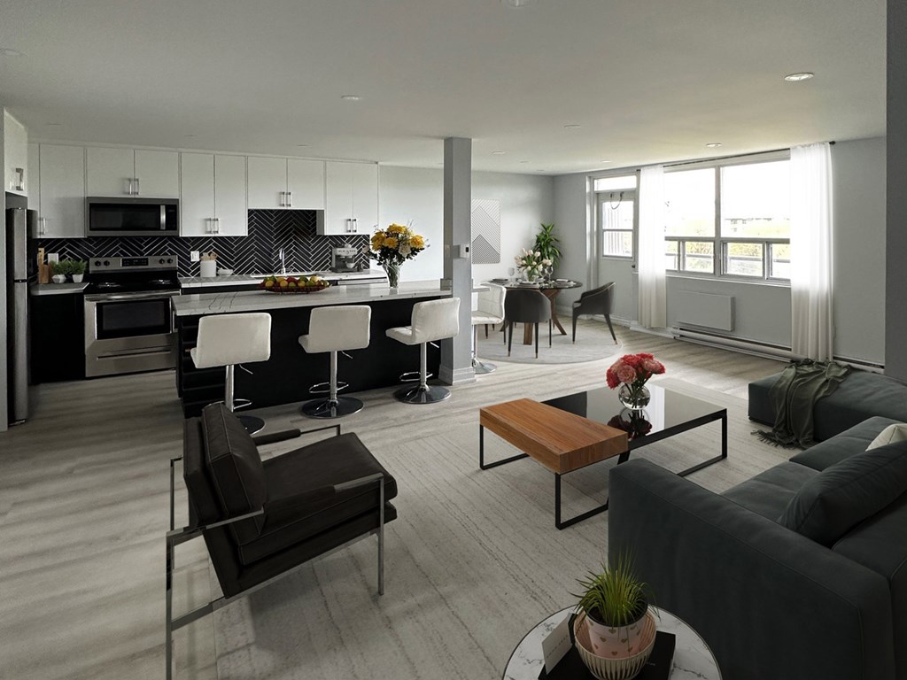 A modern living room with a kitchen in the background.