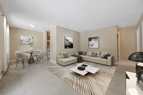 A living room with a white couch and a coffee table.